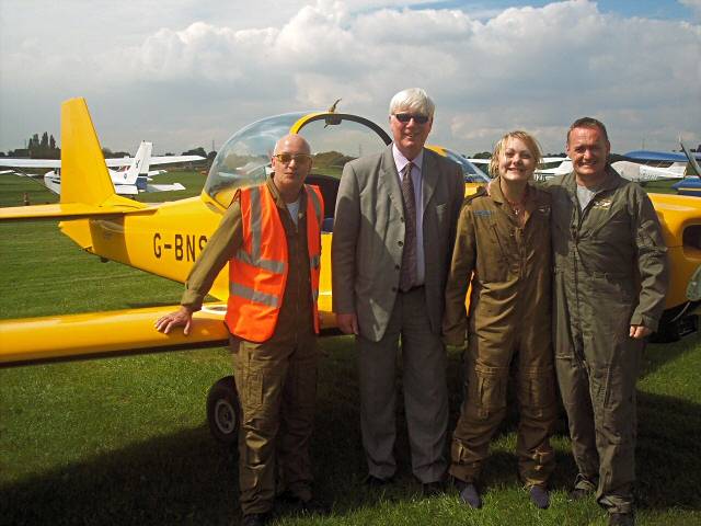 Vinny Haigherty, Paul Rowen MP and a young flyer, Lauren, with pilot Adrian Matthews