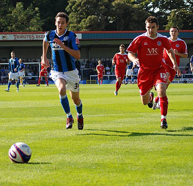 Will Buckley and former Dale man Alan Goodall chase the ball down.