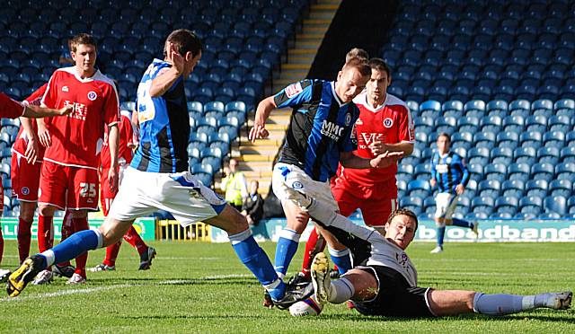 Rory McArdle and Rhodes try to turn the ball in with Carson grounded.