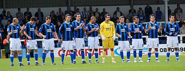 Rochdale's players celebrate Paul Conway's life during a minute's applause during the club's last home game.