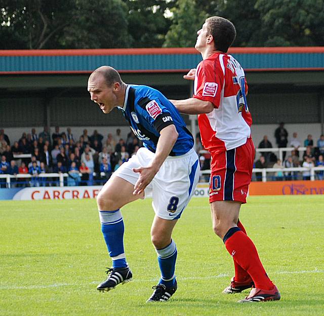 Gary Jones went down under this challenge from Mousinho but referee waived away the penalty appeals.