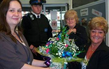 Councillor Jean Ashworth is presented with flowers from Smallbridge Senior Librarian Sue Wellins for her support with the library.