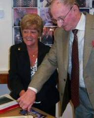 Councillors Jean Ashworth and Ted Flynn cut the cake to celebrate the re-opening of Smallbridge Library.