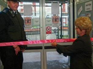 Councillor Ashworth cuts the ribbon to mark the re-opening of Smallbridge Library.