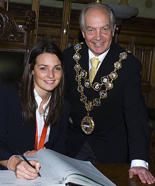 Keri-Anne signs the guestbook at Rochdale Town Hall alongside Mayor Councillor Robin Parker.