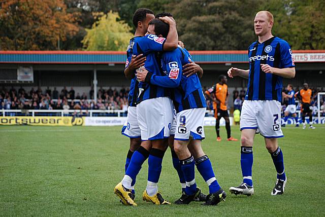 Dagnall is mobbed by his team mates after giving Dale the lead.