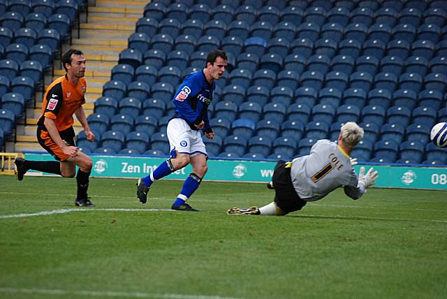 Dagnall fires wide after getting past Breen.