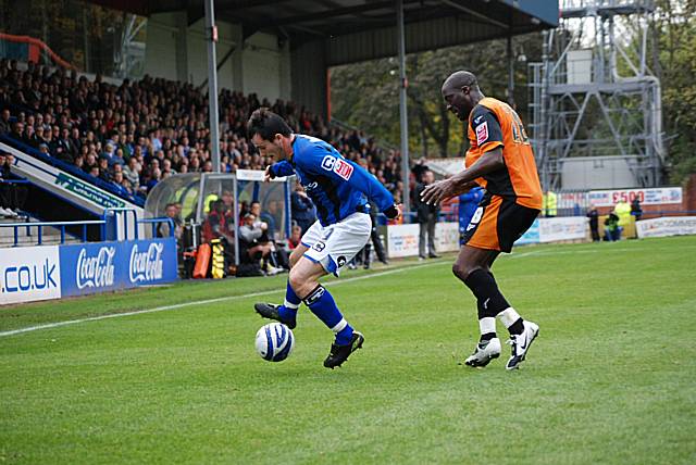 Dagnall holds the ball away from Paul Furlong.