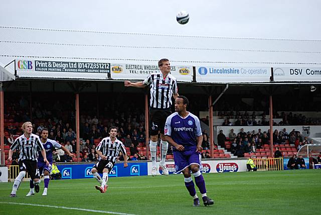 A Grimsby defender gets above Chris O'Grady to clear.