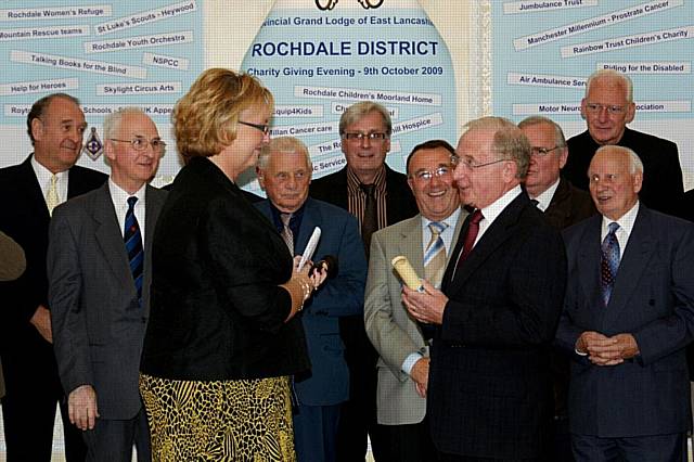 Christine Webb from Rochdale Springhill Hospice receiving the Commemorative Certificate from District Deputy Chairman Peter Hewitt.