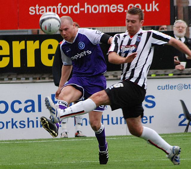 Gary Jones puts in a cross.