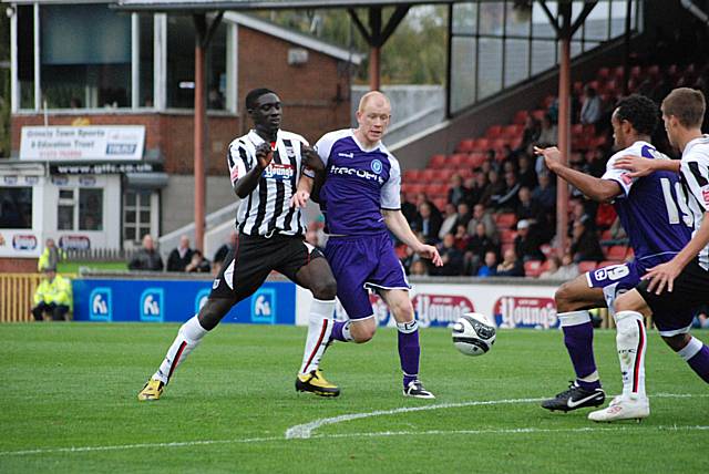 Jason Kennedy and Mendy battle for the ball on the edge of the Grimsby box.