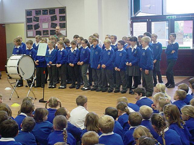 The Smithy Bridge Primary School choir perform for the Mayor and Mayoress and their fellow pupils.