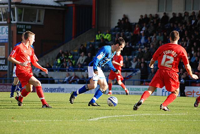 Chris Dagnall drives at the Accrington defence.