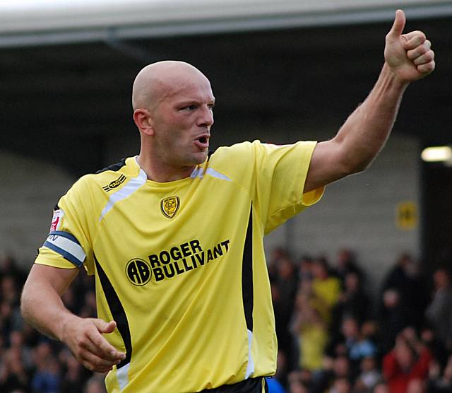 Branston gives a thumbs up to the Rochdale supporters as they praise his man-of-the-match performance.