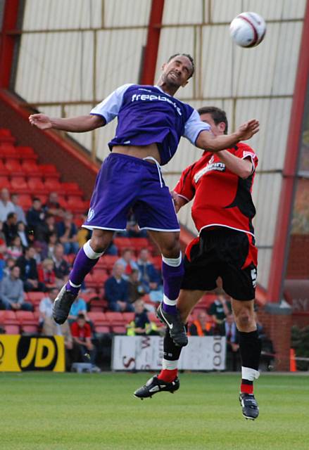 Chris O'Grady nods the ball on.