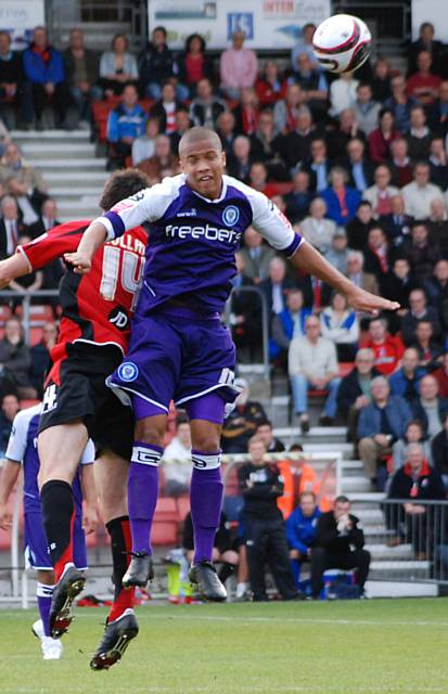 Thompson and Danny Hollands challenge for a header.