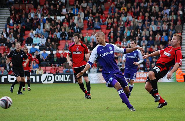 Lee Bradbury gets a pass away under pressure from Joe Thompson.