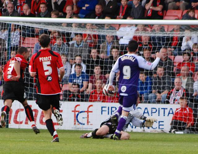 Chris Dagnall chips the ball over Shwan Jalal to give Rochdale the lead right on half time.