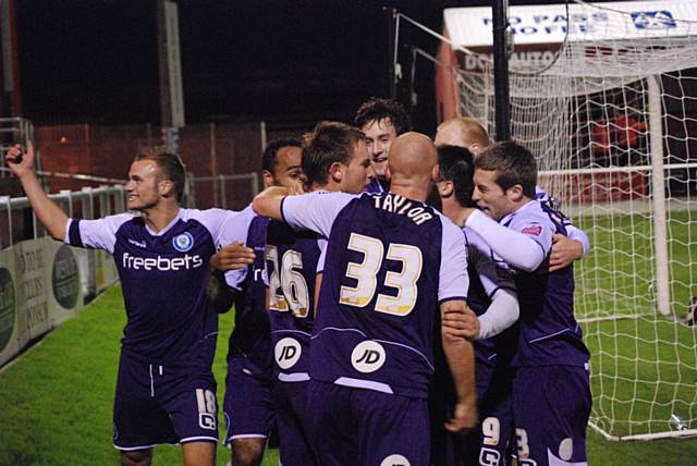 The Dale players mob Dawson following his winner.