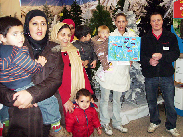 Parents and children meet with garden centre staff

 
