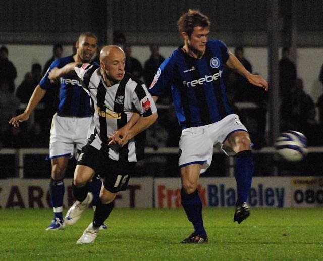 Scott Wiseman hooks the ball clear from Luke Rodgers.