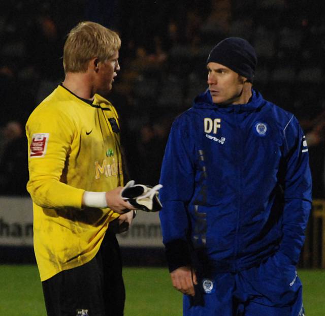 Notts keeper Kaspar Schmeichel and Rochdale assistant manager Dave Flitcroft continue the inquest into the Dale penalty after the full time whistle.