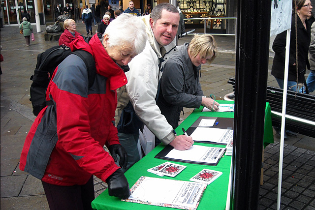 People signing 'Bring Our Troops Home by Christmas' petitions and postcards on Yorkshire Street. 