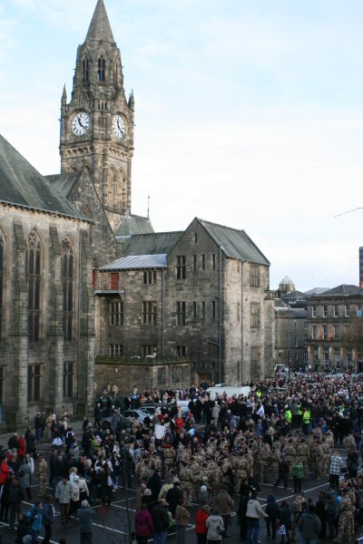 The fusiliers meet with family and friends at the town hall.