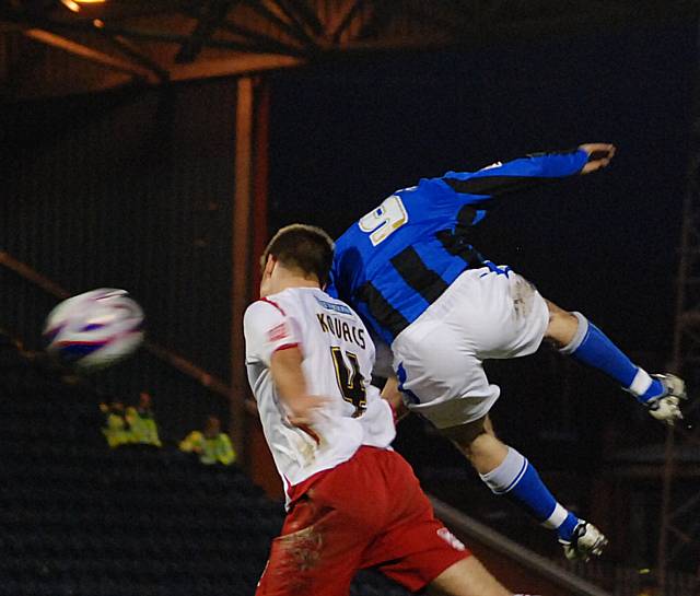 Chris Dagnall goes up for a late header with Kovacs.