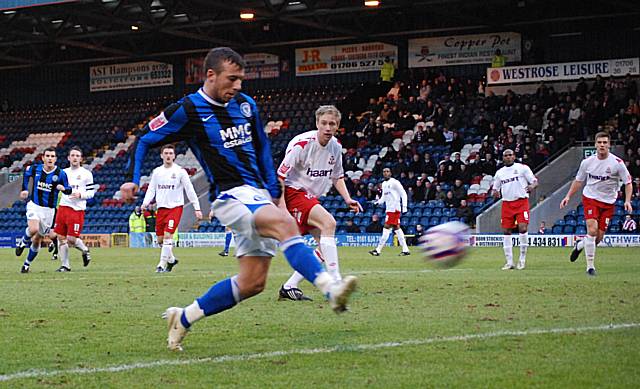 Le Fondre smashes the ball into the net.