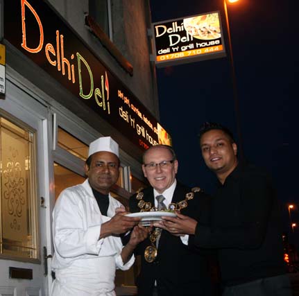 The Mayor of Rochdale Councillor Keith Swift outside Delhi Deli with owner Raja Miah and the Chef.