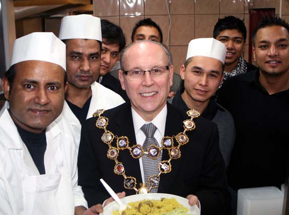 The staff at Delhi Deli gather around the Mayor of Rochdale