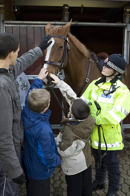 Children stroke the Police horse at the mounted and dogs unit in Chorlton-cum-Hardy, Manchester