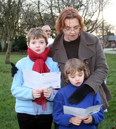 A family singing along to Milnrow Junior Brass Band at Queen's Park