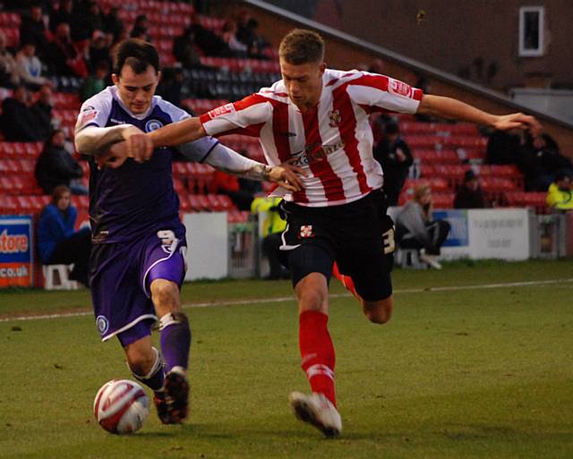 Dagnall tussles with Baker.