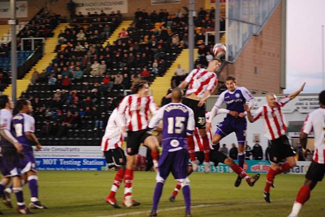 Craig Dawson rises to head Rochdale in front at Lincoln on Saturday.