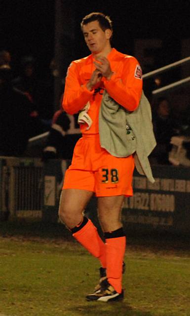 Tom Heaton applauds the supporters at full time.