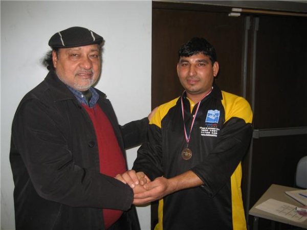 Abdur Rehman receives his man of the match award from Empire's Mr Tufail.