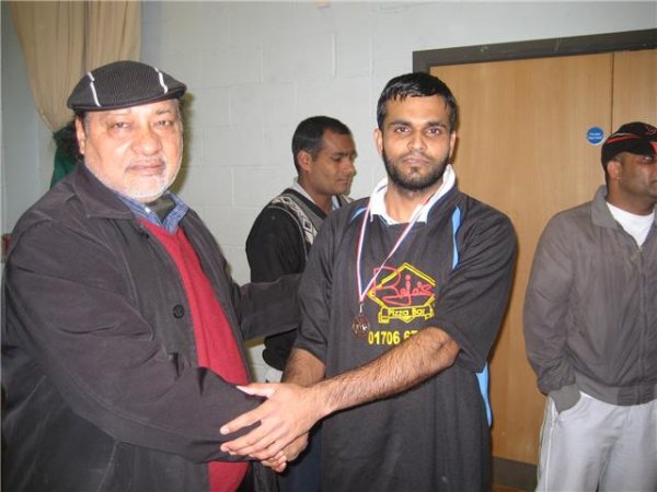 Dastaghir receives his man of the match award from Mr Tufail.