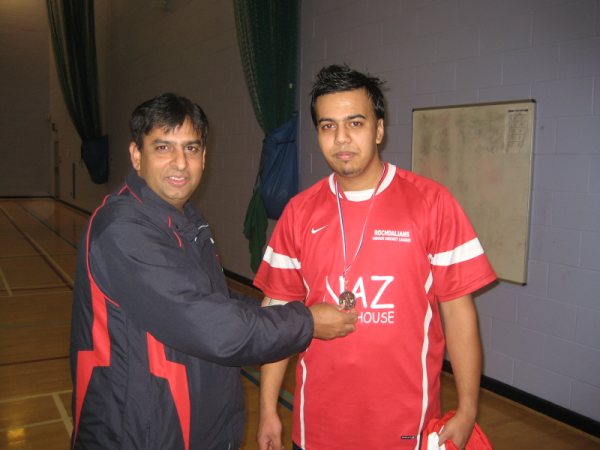 Malik receives his man-of-the-match medal.