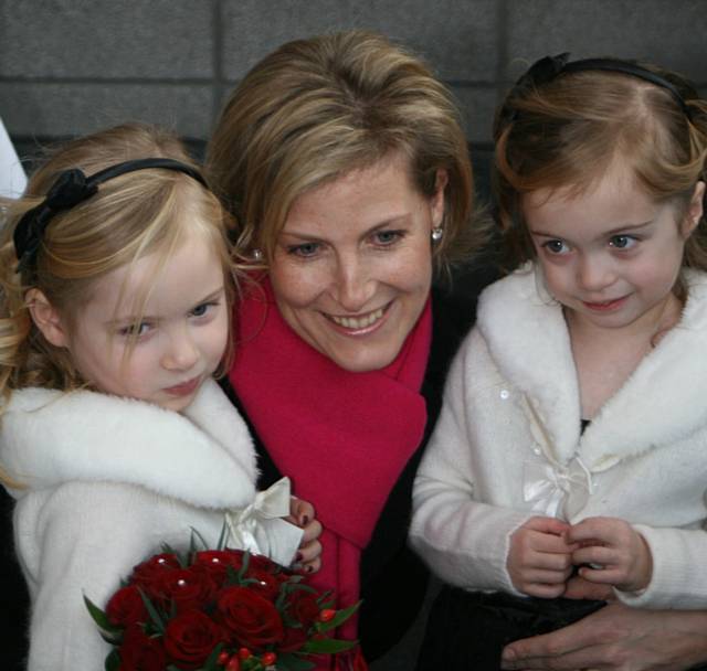 The Countess of Wessex receives flowers from Middleton twins Katie and Lauren Williams, aged four at the official opening of the Middleton Arena