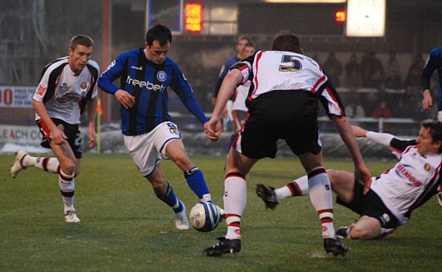 Chris Dagnall looks to evade a Shrewsbury challenge.