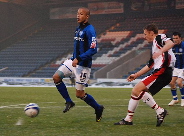 Joe Thompson holds up the ball in the Shrewsbury box.