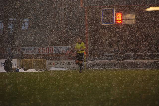 The referee leaves fans with hearts in their mouths as he stops the game during the heavy snowfall. Thankfully the stoppage was only made to change to a yellow ball.