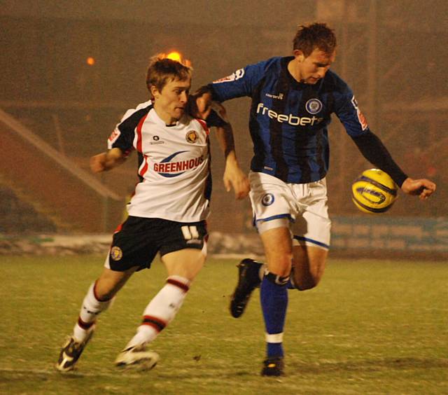 Dawson shields the ball away from Jake Robinson.