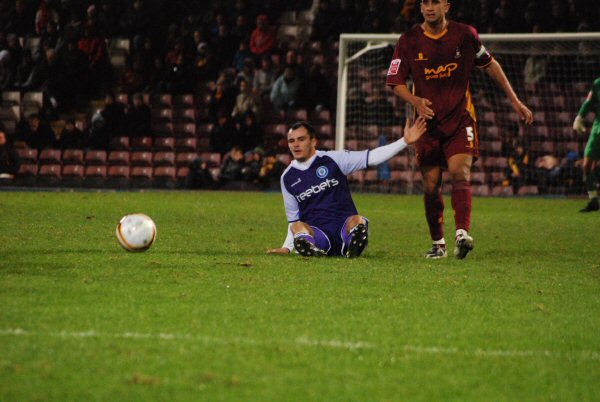 Dagnall is grounded following a tackle.