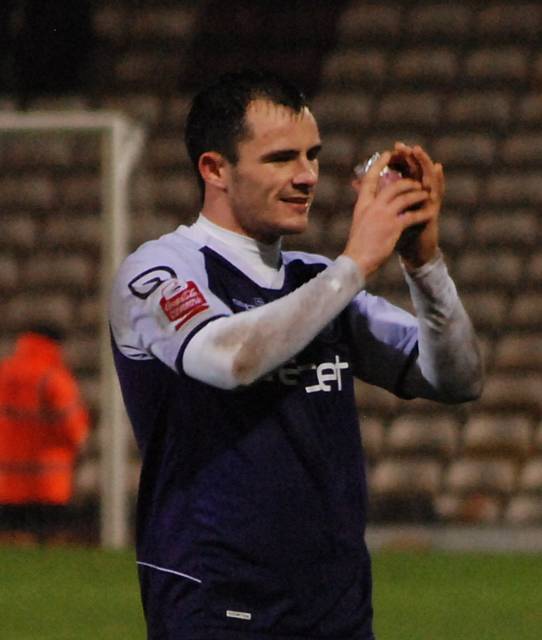 Dagnall applauds the supporters at full time.