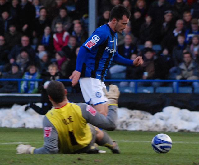 Dagnall takes the ball round Barry Roche before doubling Rochdale's lead.