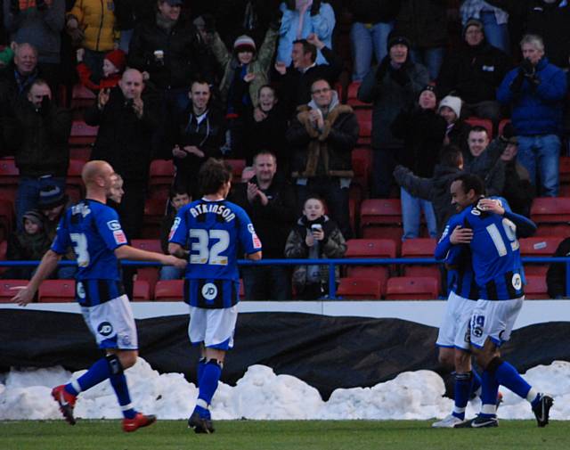 The players celebrate after Dagnall doubles Dale's lead.